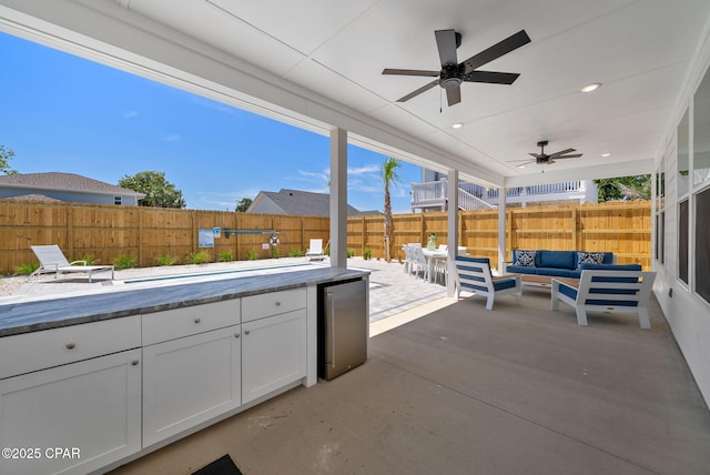 309 Tanaga St, Panama City Beach, FL 32413 - fenced backyard featuring outdoor lounge area, ceiling fan, and a patio