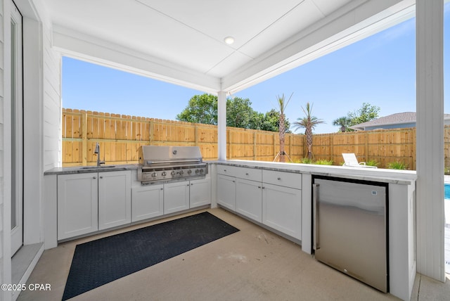 309 Tanaga St, Panama City Beach, FL 32413 - fenced backyard with exterior kitchen and a sink