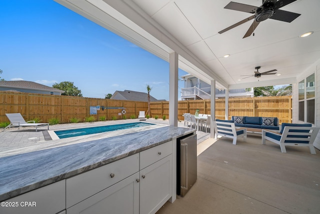 309 Tanaga St, Panama City Beach, FL 32413 - fenced backyard with an outdoor living space, ceiling fan, and a patio