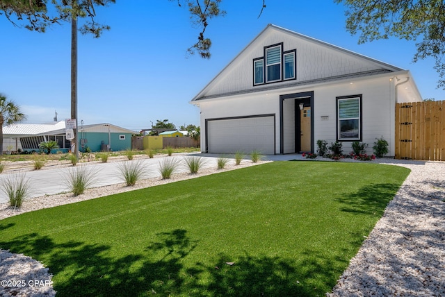 309 Tanaga St, Panama City Beach, FL 32413 - view of front of house featuring driveway, a garage, and a gate