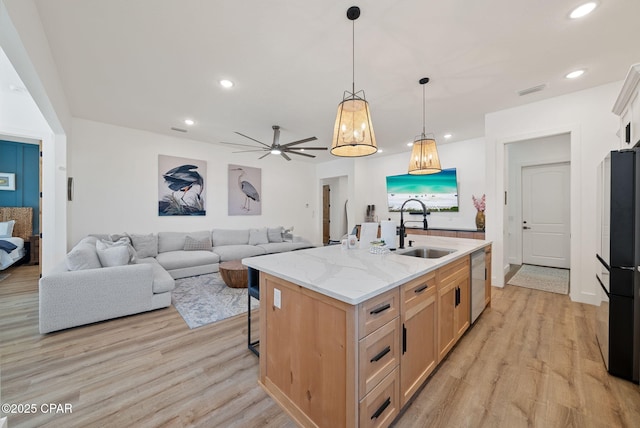 309 Tanaga St, Panama City Beach, FL 32413 - kitchen featuring freestanding refrigerator, dishwasher, light wood finished floors, an island with sink, and recessed lighting