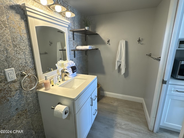 14401 Front Beach Rd Unit 221, Panama City Beach, FL 32413 - bathroom with vanity, wood finished floors, and baseboards
