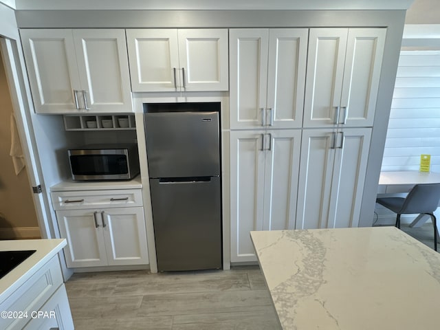 14401 Front Beach Rd Unit 221, Panama City Beach, FL 32413 - kitchen with stainless steel appliances, light wood-style flooring, and white cabinets