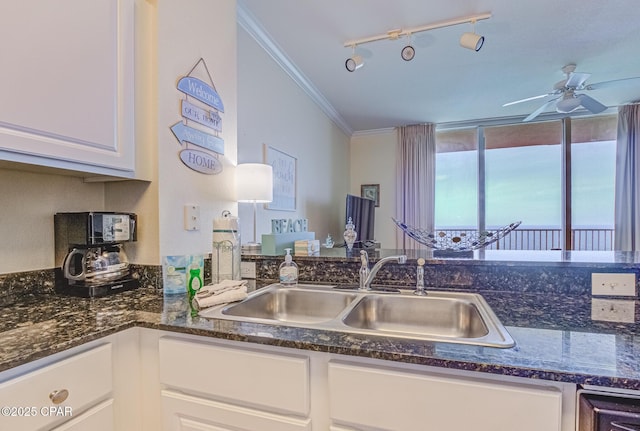 16819 Front Beach Rd Unit 2910, Panama City Beach, FL 32413 - kitchen featuring track lighting, ornamental molding, white cabinets, ceiling fan, and dark stone counters