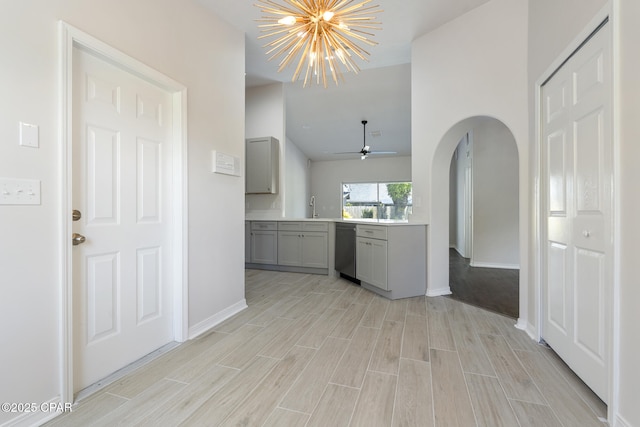 101 Loblolly Ct, Panama City Beach, FL 32413 - kitchen featuring gray cabinets, stainless steel dishwasher, a sink, and light wood-style flooring