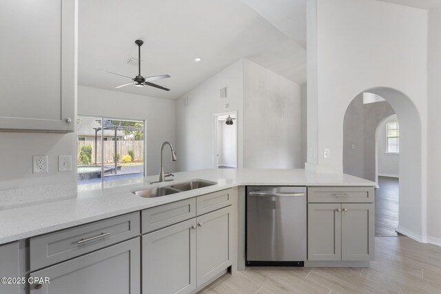 101 Loblolly Ct, Panama City Beach, FL 32413 - kitchen with stainless steel dishwasher, a sink, a ceiling fan, healthy amount of natural light, and vaulted ceiling