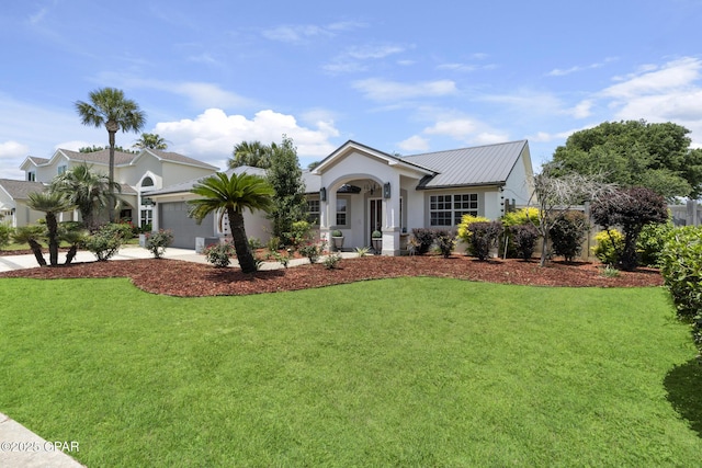 101 Loblolly Ct, Panama City Beach, FL 32413 - single story home with a garage, stucco siding, metal roof, a front yard, and driveway