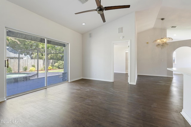 101 Loblolly Ct, Panama City Beach, FL 32413 - unfurnished living room with vaulted ceiling, a ceiling fan, arched walkways, dark wood-type flooring, and baseboards