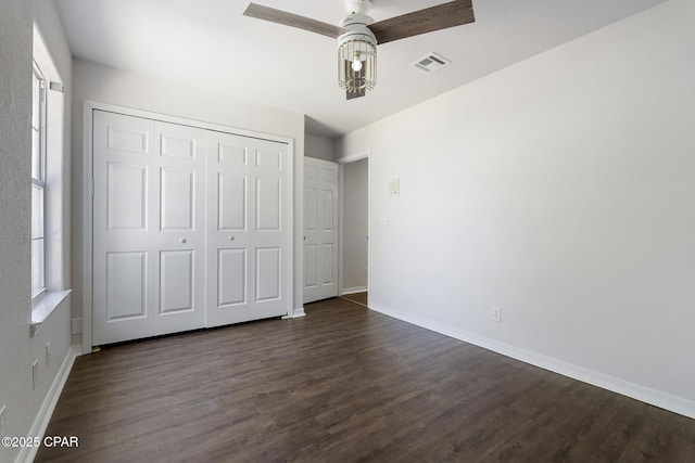 101 Loblolly Ct, Panama City Beach, FL 32413 - unfurnished bedroom featuring dark wood-style floors, baseboards, and a closet