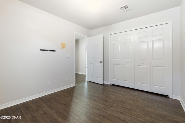 101 Loblolly Ct, Panama City Beach, FL 32413 - unfurnished bedroom featuring dark wood-style floors, baseboards, and a closet