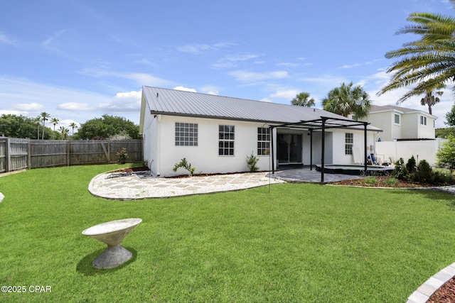 101 Loblolly Ct, Panama City Beach, FL 32413 - rear view of property featuring a patio, stucco siding, and metal roof