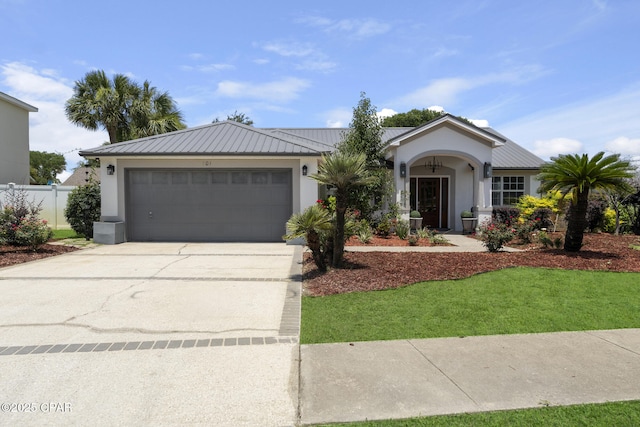 101 Loblolly Ct, Panama City Beach, FL 32413 - single story home featuring stucco siding, concrete driveway, an attached garage, and metal roof