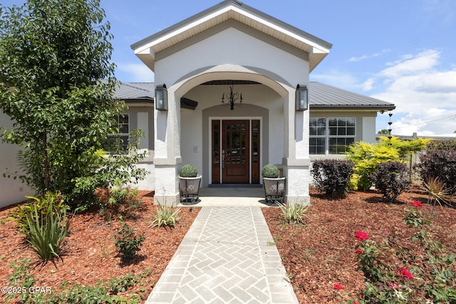 101 Loblolly Ct, Panama City Beach, FL 32413 - entrance to property with metal roof, stucco siding, and a standing seam roof