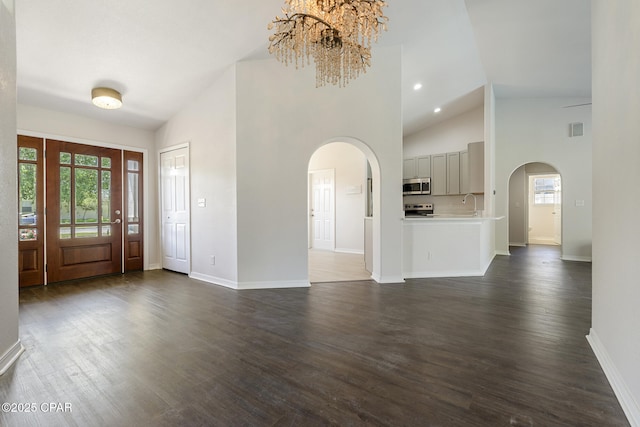 101 Loblolly Ct, Panama City Beach, FL 32413 - entrance foyer with arched walkways, plenty of natural light, baseboards, and high vaulted ceiling