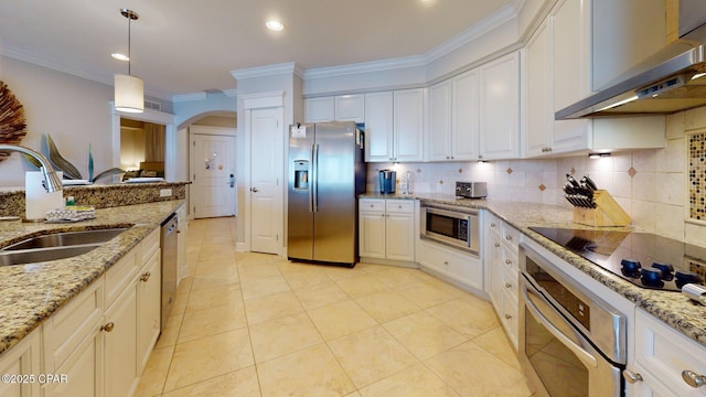 11807 Front Beach Rd Unit 2204, Panama City Beach, FL 32407 - kitchen featuring appliances with stainless steel finishes, extractor fan, a sink, arched walkways, and backsplash