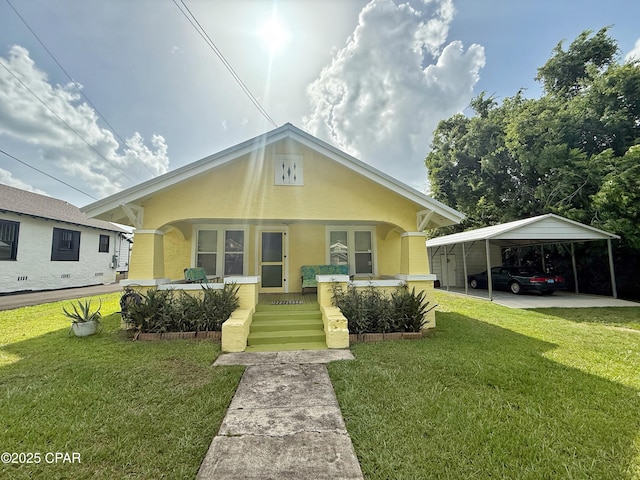 2969 Russ St, Marianna, FL 32446 - bungalow with a front lawn, a detached carport, and stucco siding