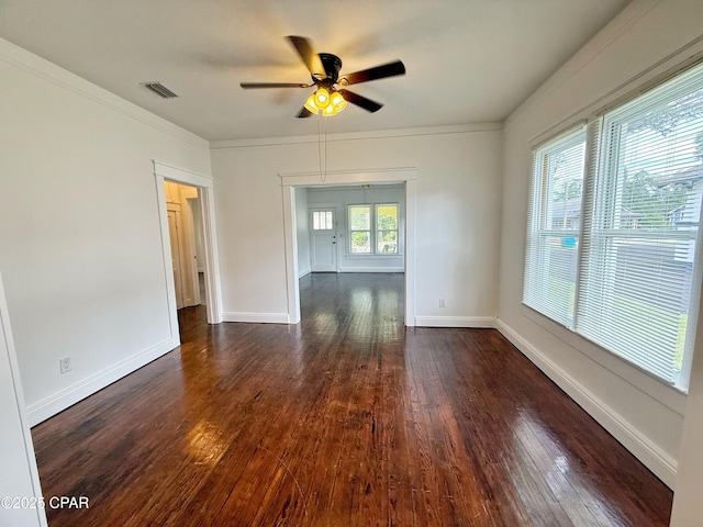 2969 Russ St, Marianna, FL 32446 - empty room featuring ceiling fan, dark wood-style flooring, baseboards, and crown molding