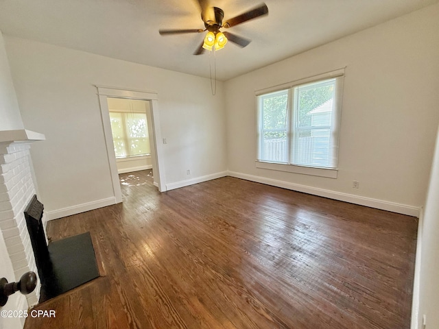 2969 Russ St, Marianna, FL 32446 - unfurnished living room featuring a fireplace, ceiling fan, dark wood-type flooring, and baseboards