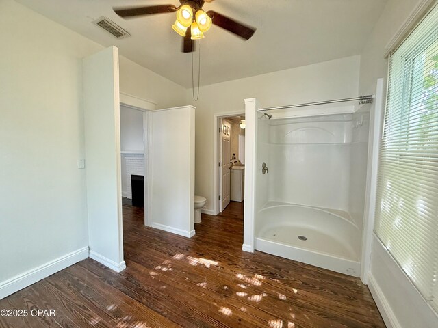 2969 Russ St, Marianna, FL 32446 - full bath with a ceiling fan, a walk in shower, toilet, hardwood / wood-style flooring, and baseboards