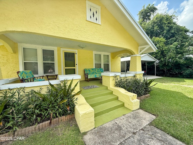 2969 Russ St, Marianna, FL 32446 - view of exterior entry featuring stucco siding, a yard, outdoor lounge area, and a patio