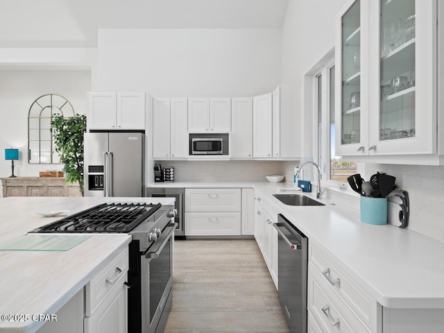 766 Secluded Dunes Dr, Port St Joe, FL 32456 - kitchen featuring stainless steel appliances, backsplash, light countertops, and white cabinets