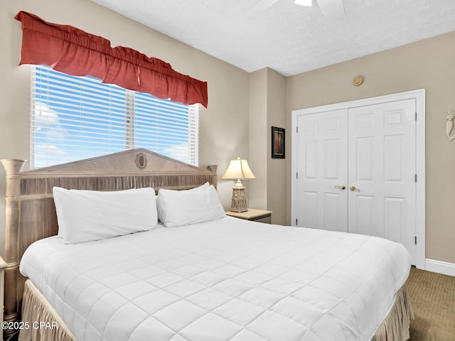 7115 Thomas Dr Unit 602, Panama City Beach, FL 32408 - carpeted bedroom with a closet, a textured ceiling, and a ceiling fan