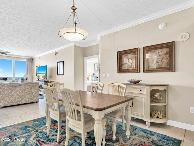 7115 Thomas Dr Unit 602, Panama City Beach, FL 32408 - dining space featuring light tile patterned floors, a textured ceiling, and crown molding
