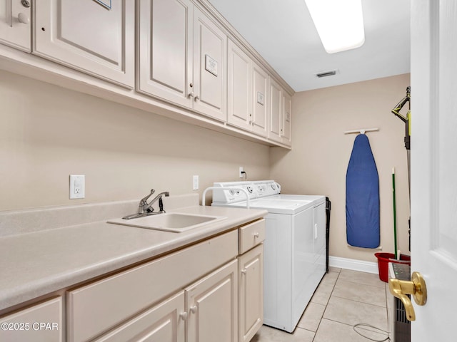 7115 Thomas Dr Unit 602, Panama City Beach, FL 32408 - laundry area featuring washer and dryer, cabinet space, and light tile patterned flooring
