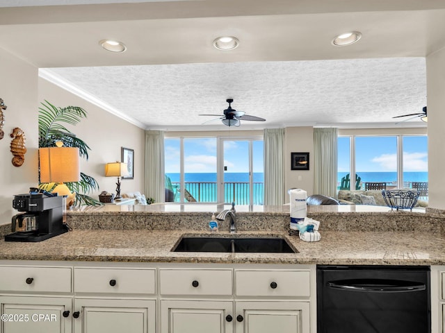 7115 Thomas Dr Unit 602, Panama City Beach, FL 32408 - kitchen featuring dishwasher, ceiling fan, a textured ceiling, a water view, and ornamental molding