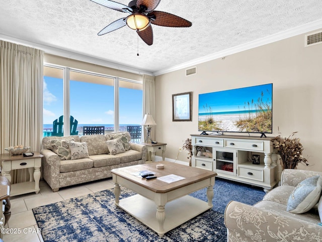 7115 Thomas Dr Unit 602, Panama City Beach, FL 32408 - living room with a ceiling fan, a textured ceiling, tile patterned flooring, and crown molding
