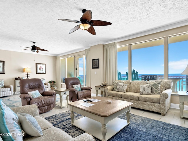 7115 Thomas Dr Unit 602, Panama City Beach, FL 32408 - living room featuring a ceiling fan, tile patterned flooring, and a textured ceiling