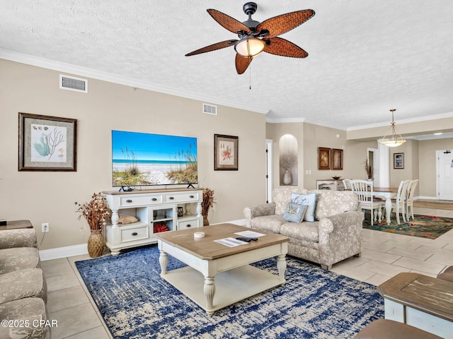 7115 Thomas Dr Unit 602, Panama City Beach, FL 32408 - living area with ceiling fan, a textured ceiling, light tile patterned floors, and ornamental molding