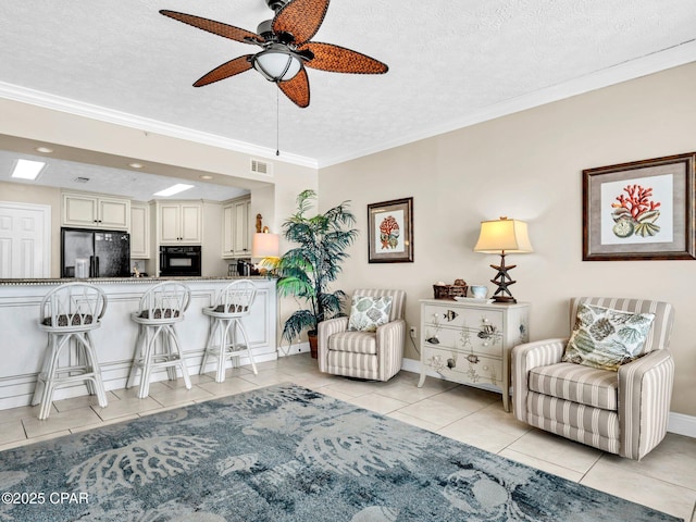 7115 Thomas Dr Unit 602, Panama City Beach, FL 32408 - living room featuring light tile patterned flooring, a ceiling fan, a textured ceiling, and crown molding