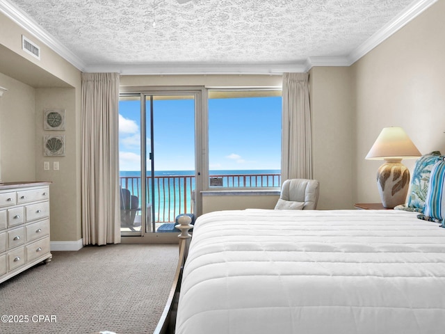 7115 Thomas Dr Unit 602, Panama City Beach, FL 32408 - bedroom with a water view, access to outside, a textured ceiling, crown molding, and multiple windows