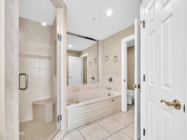 7115 Thomas Dr Unit 602, Panama City Beach, FL 32408 - bathroom featuring a shower stall, a garden tub, and tile patterned flooring