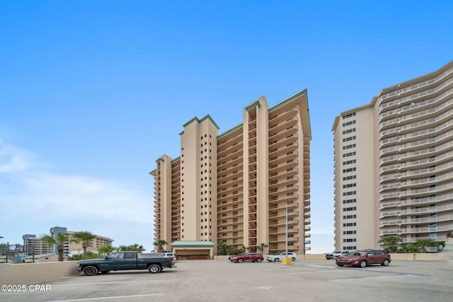 7115 Thomas Dr Unit 602, Panama City Beach, FL 32408 - view of apartment building / complex featuring uncovered parking