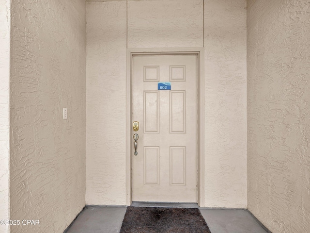 7115 Thomas Dr Unit 602, Panama City Beach, FL 32408 - view of exterior entry featuring stucco siding