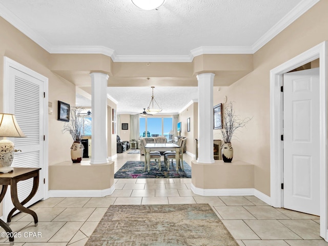 7115 Thomas Dr Unit 602, Panama City Beach, FL 32408 - entryway featuring ornate columns, a textured ceiling, ornamental molding, and light tile patterned floors