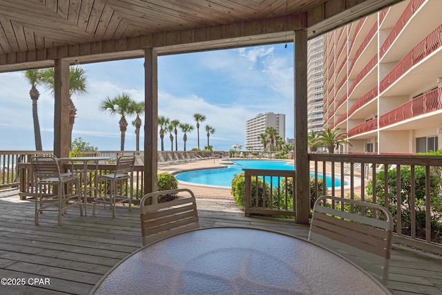 7115 Thomas Dr Unit 602, Panama City Beach, FL 32408 - deck with outdoor dining area and a community pool