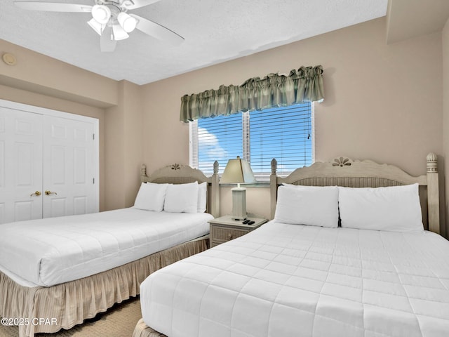 7115 Thomas Dr Unit 602, Panama City Beach, FL 32408 - bedroom featuring ceiling fan and a textured ceiling