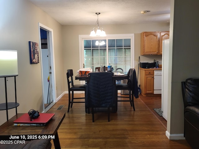 4881 Tall Pine Dr, Marianna, FL 32446 - dining area featuring a chandelier and dark wood finished floors