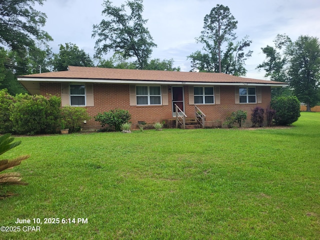4881 Tall Pine Dr, Marianna, FL 32446 - ranch-style home featuring brick siding and a front yard