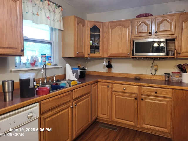 4881 Tall Pine Dr, Marianna, FL 32446 - kitchen with stainless steel microwave, white dishwasher, glass insert cabinets, and dark wood-style floors