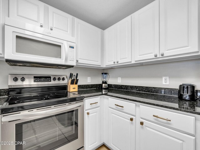 15817 Front Beach Rd Unit 1-204, Panama City Beach, FL 32413 - kitchen with white microwave, stainless steel electric range, white cabinets, and dark stone counters