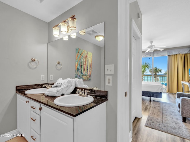 15817 Front Beach Rd Unit 1-204, Panama City Beach, FL 32413 - ensuite bathroom featuring double vanity, a ceiling fan, and wood finished floors