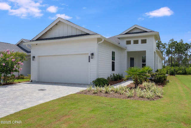 118 Ravine Rd, Inlet Beach, FL 32461 - view of front of house featuring a garage, board and batten siding, a front yard, and decorative driveway