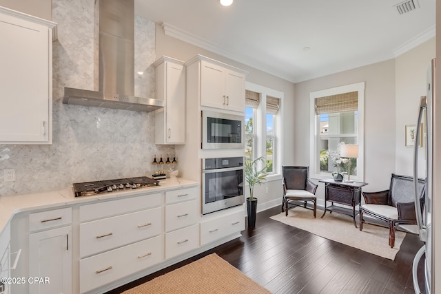 118 Ravine Rd, Inlet Beach, FL 32461 - kitchen featuring appliances with stainless steel finishes, wall chimney exhaust hood, ornamental molding, decorative backsplash, and white cabinetry