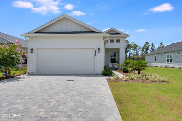118 Ravine Rd, Inlet Beach, FL 32461 - view of front facade with a front lawn, decorative driveway, an attached garage, and board and batten siding