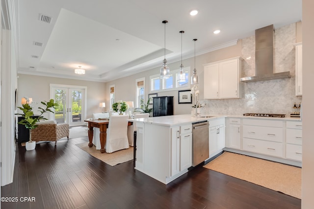 118 Ravine Rd, Inlet Beach, FL 32461 - kitchen with wall chimney exhaust hood, appliances with stainless steel finishes, a peninsula, a tray ceiling, and recessed lighting