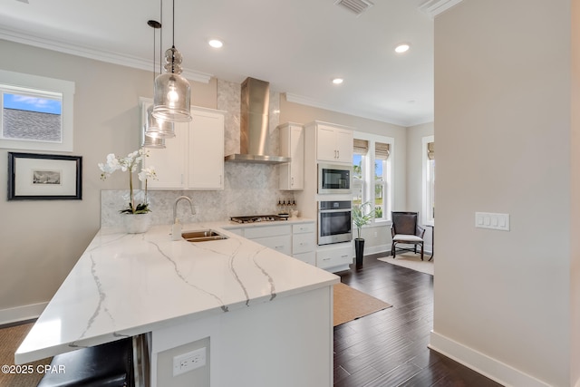 118 Ravine Rd, Inlet Beach, FL 32461 - kitchen with appliances with stainless steel finishes, wall chimney range hood, ornamental molding, tasteful backsplash, and white cabinets